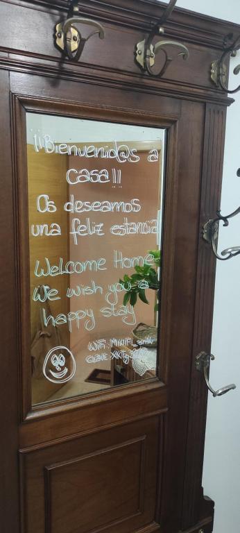 a sign on a glass door with writing on it at Piso As Rodas in Villanueva de Arosa