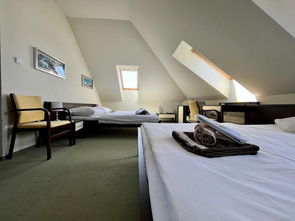 A bed or beds in a room at Penzion Félix