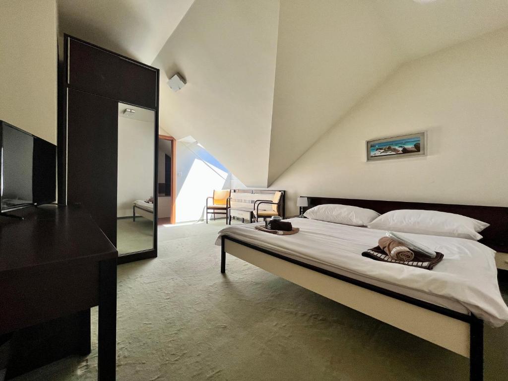 A bed or beds in a room at Penzion Félix