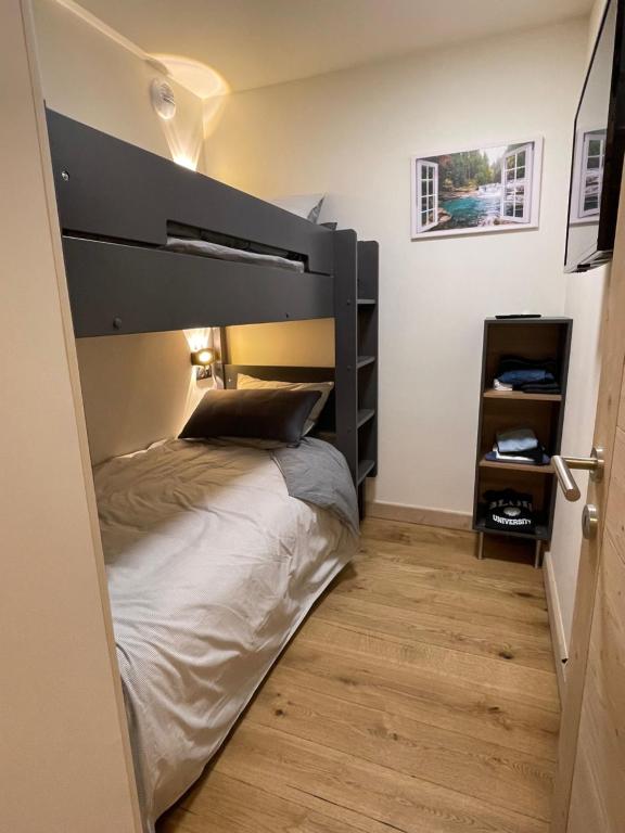 a bedroom with a large bed with a black headboard at GESPERE LE STELLA in Les Gets