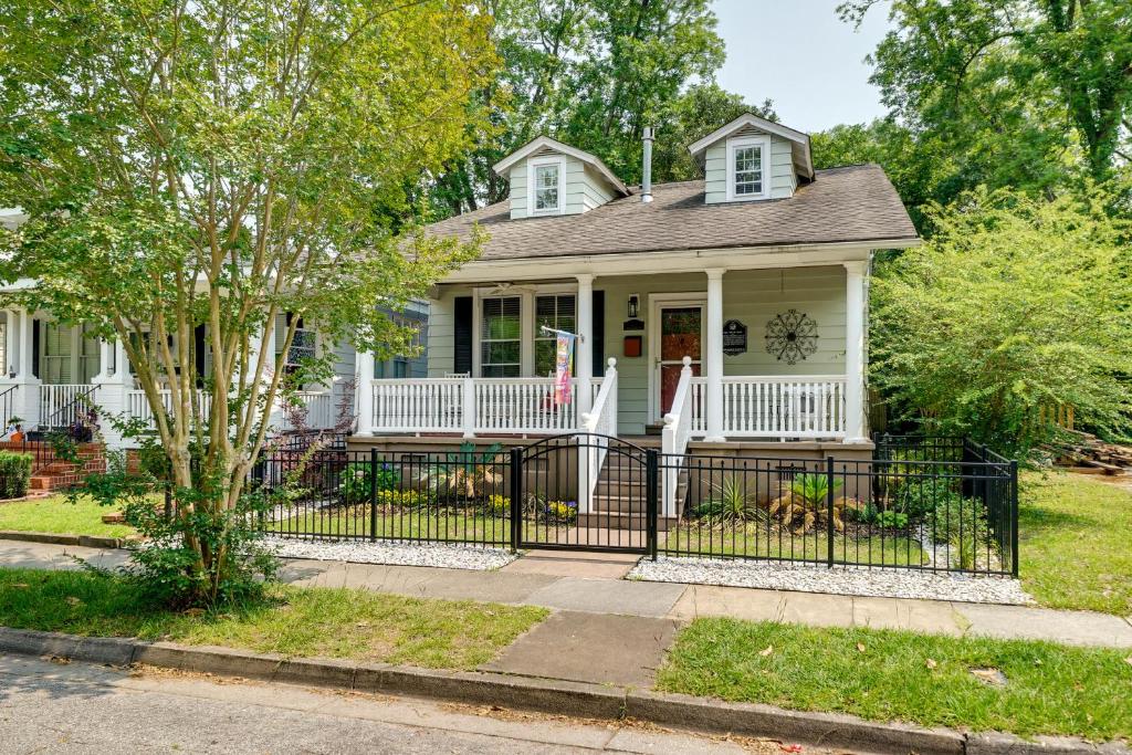 a white house with a black fence at Wilmington Vacation Rental Close to Riverwalk! in Wilmington