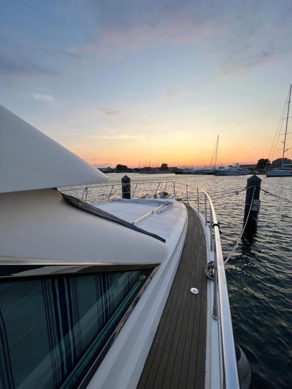 a boat is docked on the water with a sunset at Navï, yacht privé face au Mont Saint-Clair in Sète