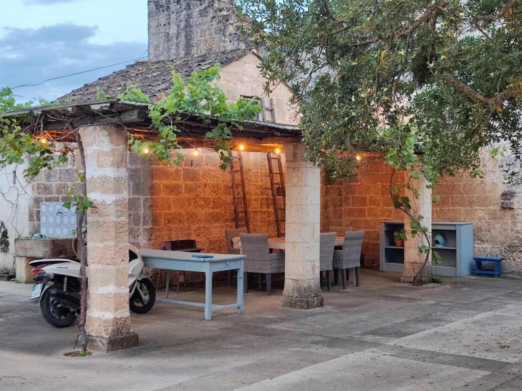 a patio with a table and chairs and a building at La Fragna in Nardò