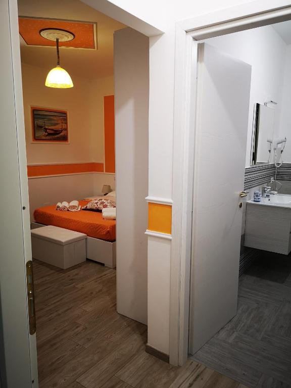 Łóżko lub łóżka w pokoju w obiekcie La Casa di Alfonso