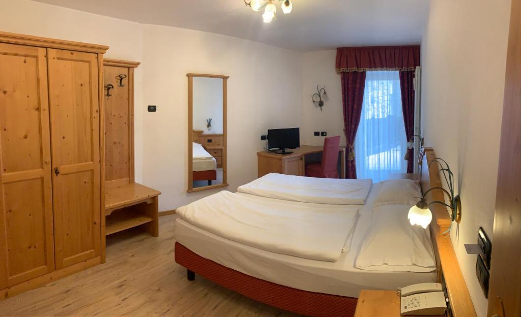 Posteľ alebo postele v izbe v ubytovaní Hotel Laurin