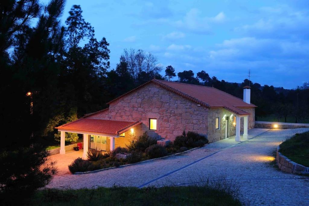 un edificio de piedra con luces delante en Casa Lagar da Moira, en Vila Franca da Serra