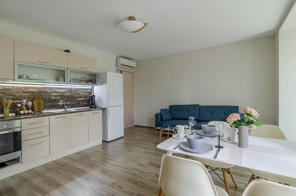 a kitchen and dining room with a table and chairs at Garden Palace in Varna City