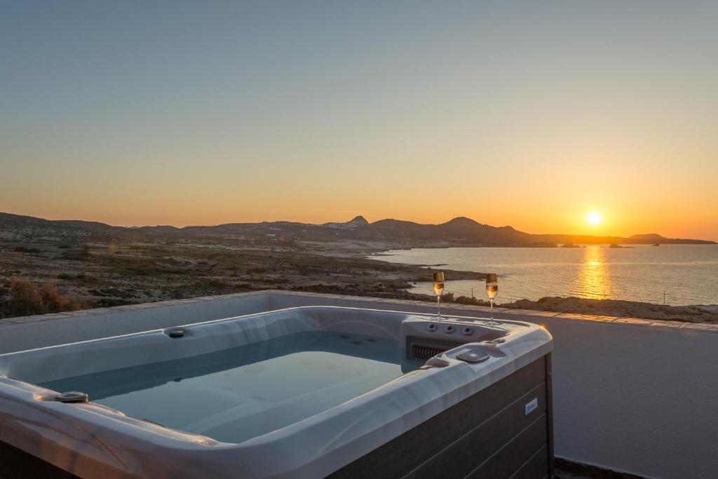 a bath tub with the sunset in the background at Iliovasilema Studios in Mytakas
