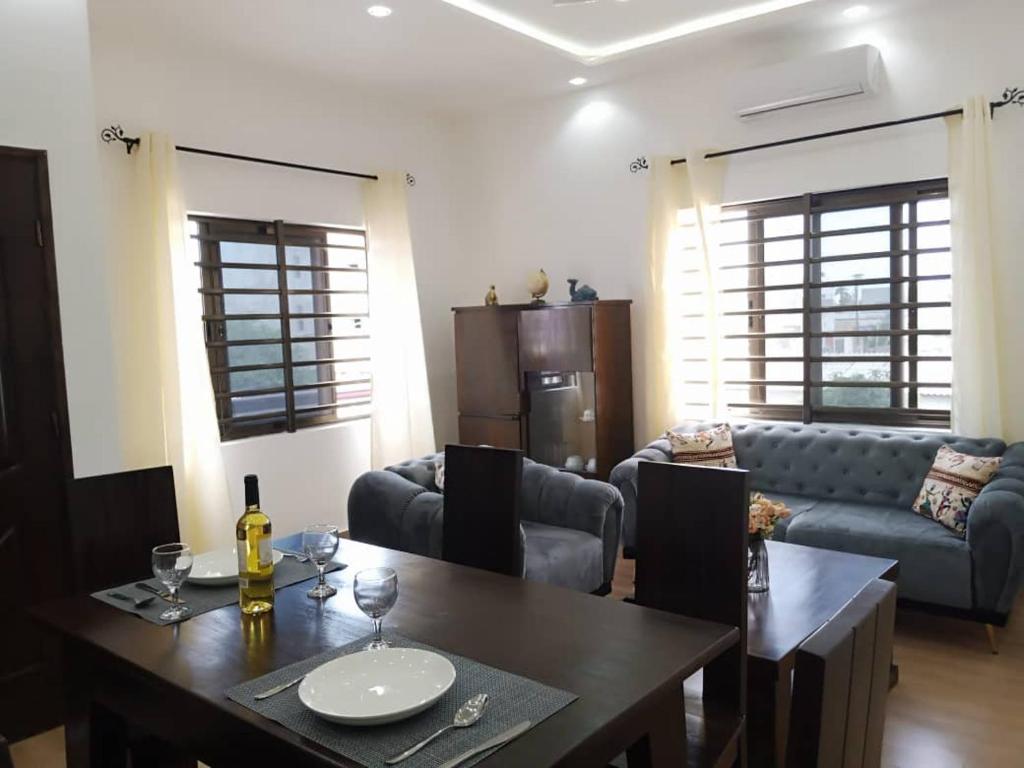 a living room with a table and a couch at Résidence des amazones Appartement 1 in Cotonou