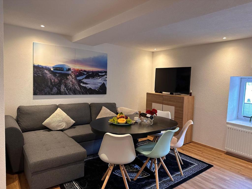 a living room with a couch and a table at Apartment Ana in Arzl im Pitztal