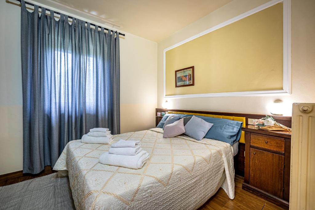 Postel nebo postele na pokoji v ubytování Hotel Minerva
