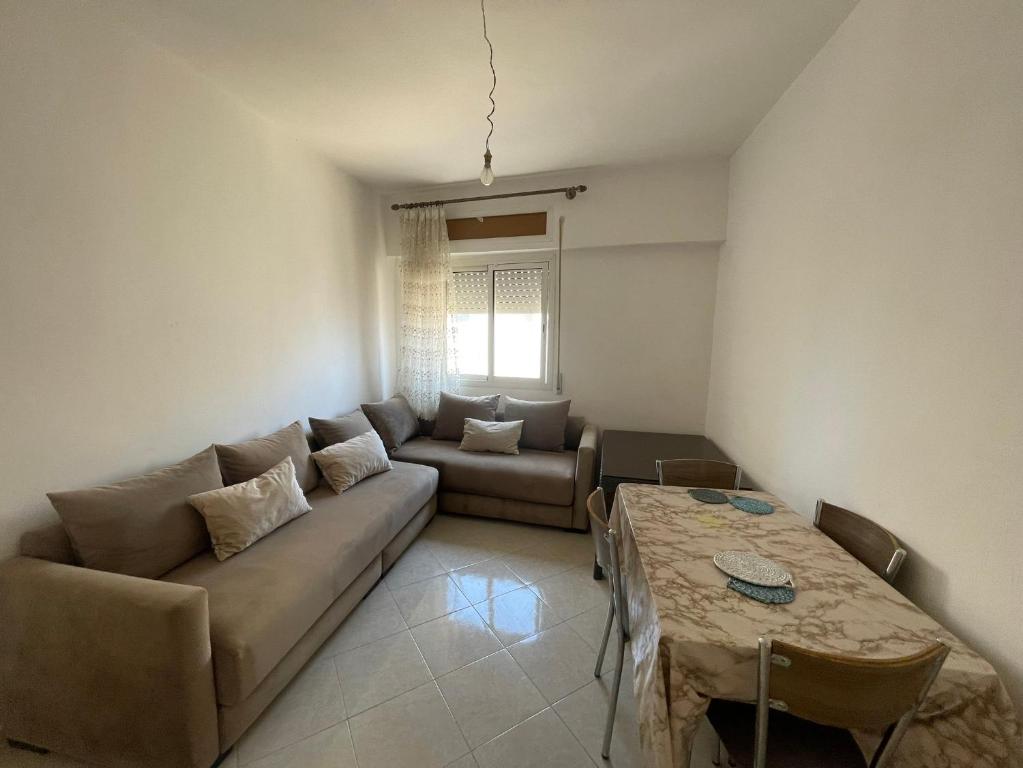 a living room with a couch and a table at Economic Apartment Alhoceima WIFI in Al Hoceïma
