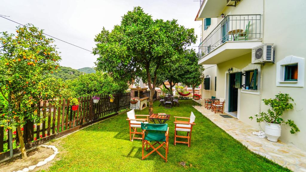 a backyard with chairs and tables and a fence at Villa Matina in Parga