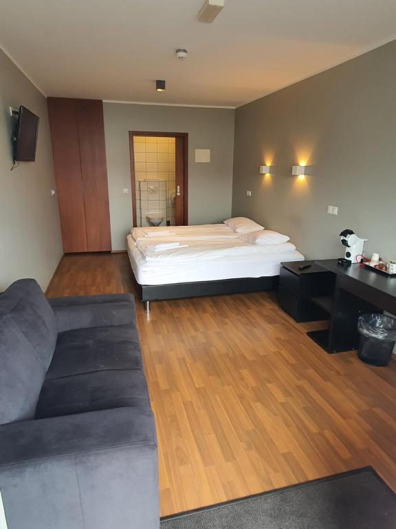 a living room with a bed and a couch at Studio 22 in Reyðarfjörður