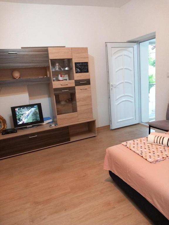 a bedroom with a bed and a tv in a room at Villa 17 in Gevgelija