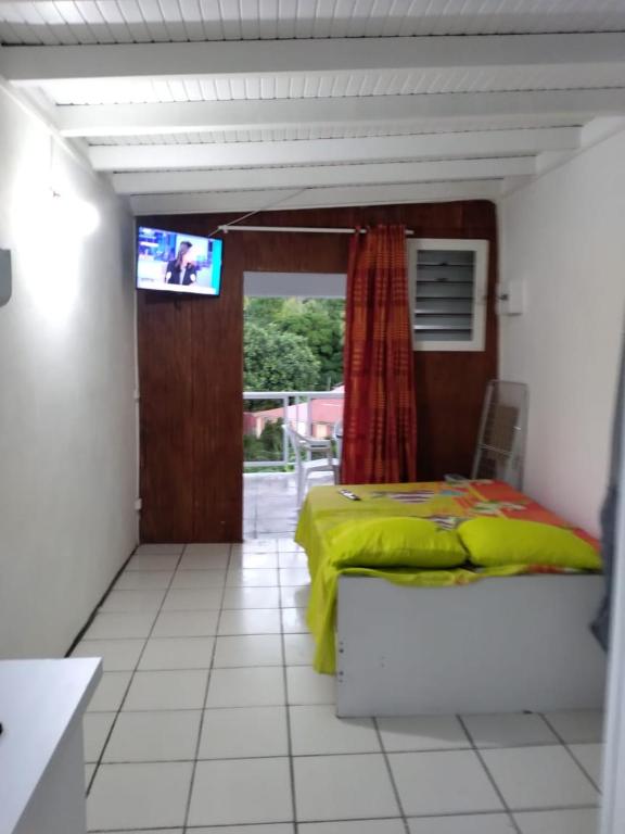 a bedroom with a bed and a television in it at Weston in Deshaies