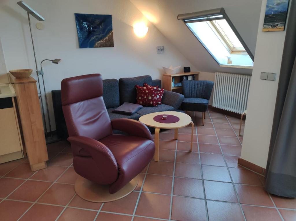 a living room with a couch and a chair and a table at Apartment Seeadler in Dewichow