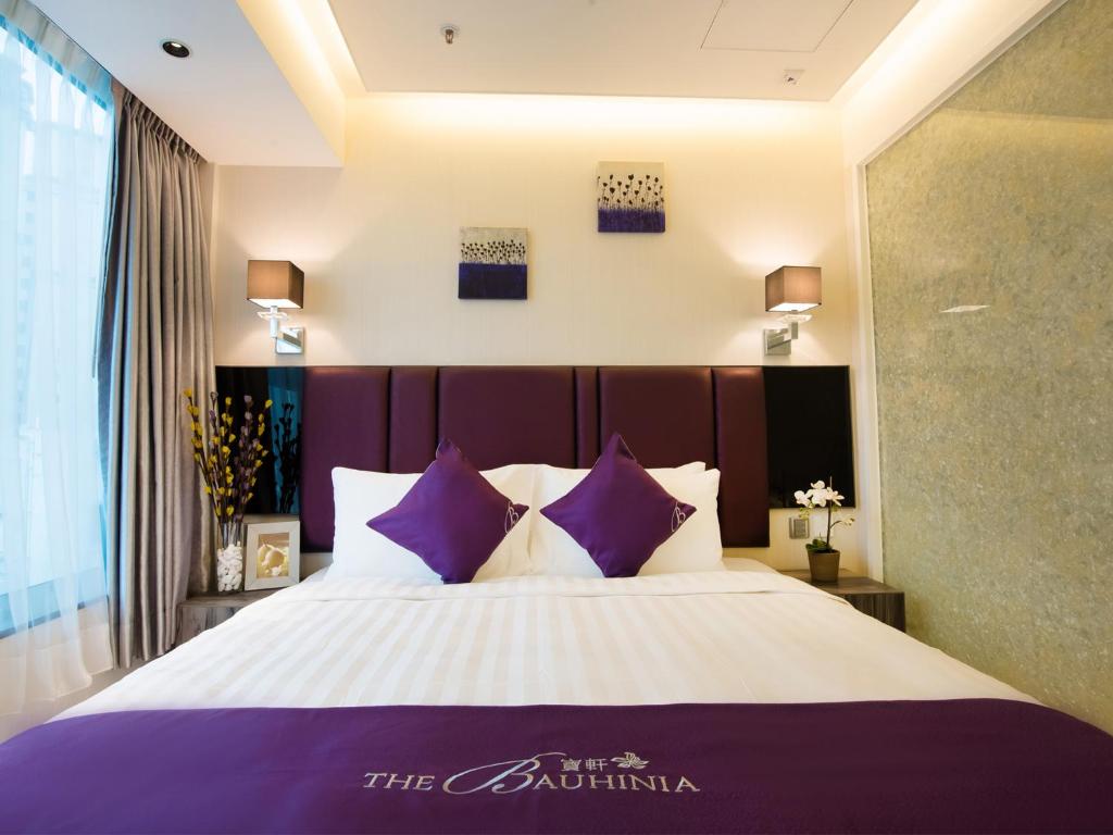 Postel nebo postele na pokoji v ubytování The Bauhinia Hotel - Tsim Sha Tsui