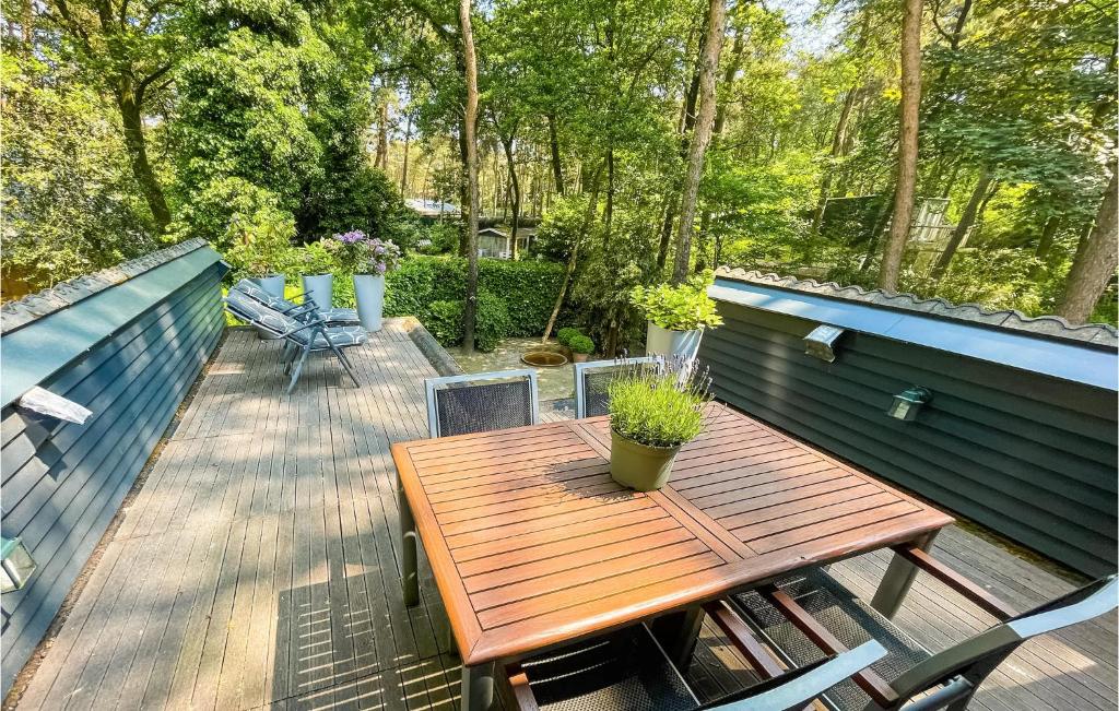 een houten tafel en stoelen op een terras bij Nice Home In Meijel With Wifi And 2 Bedrooms in Meijel
