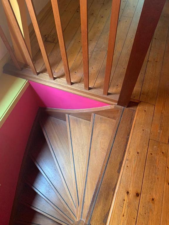 an empty wooden staircase in a room with wood floors at An Artist Created it in Middelburg