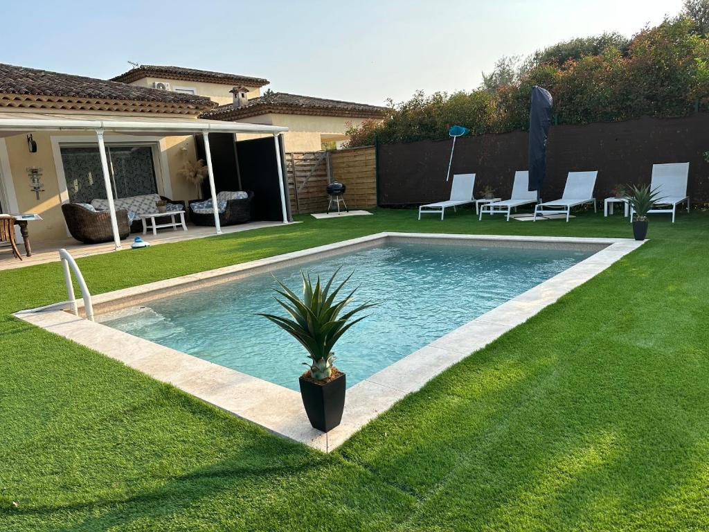 a swimming pool in the middle of a yard at Petite maisonette adossee mais independante avec piscine in Peymeinade