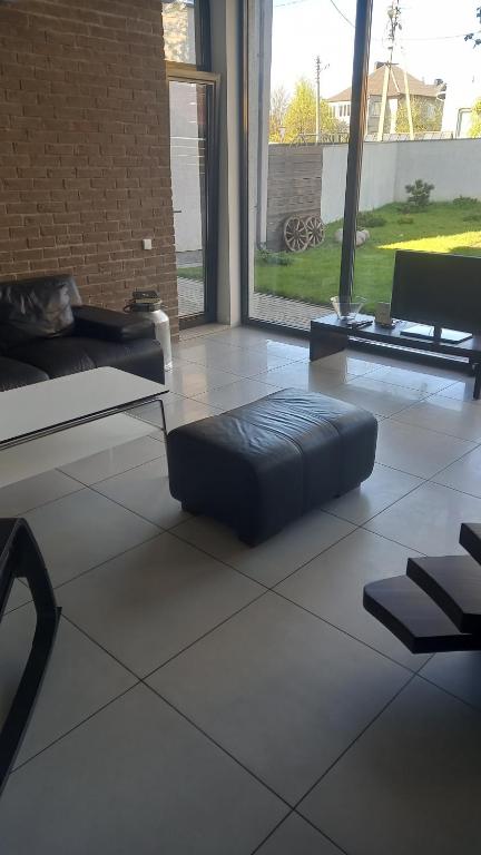 a large living room with a couch and a table at the holiday house in Klaipėda
