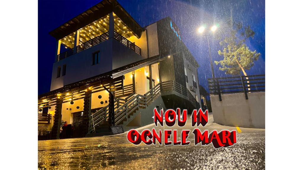 a building with a sign that says now in comall war at Bigala Ocnele Mari in Ocnele Mari