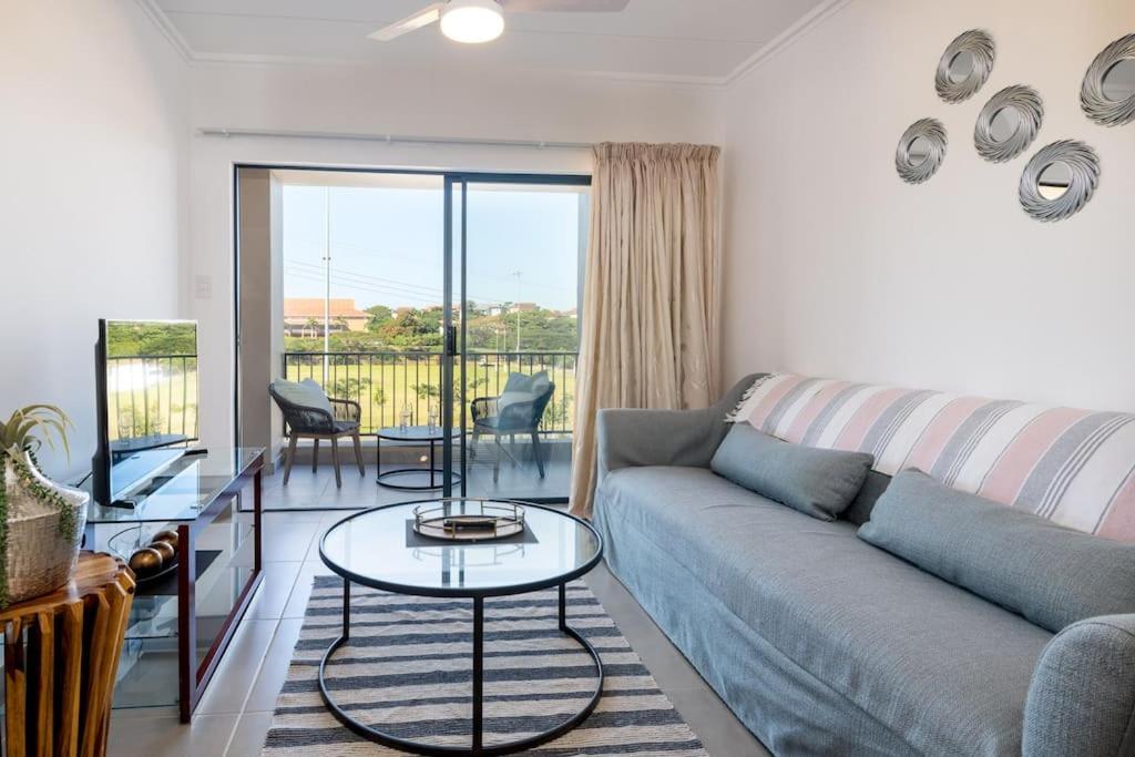 a living room with a couch and a table at Gorgeous Ballito One Bedroom apartment in Ballito