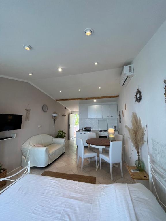 a bedroom with a bed and a table and a kitchen at Studio apartment in Ivan Dolac