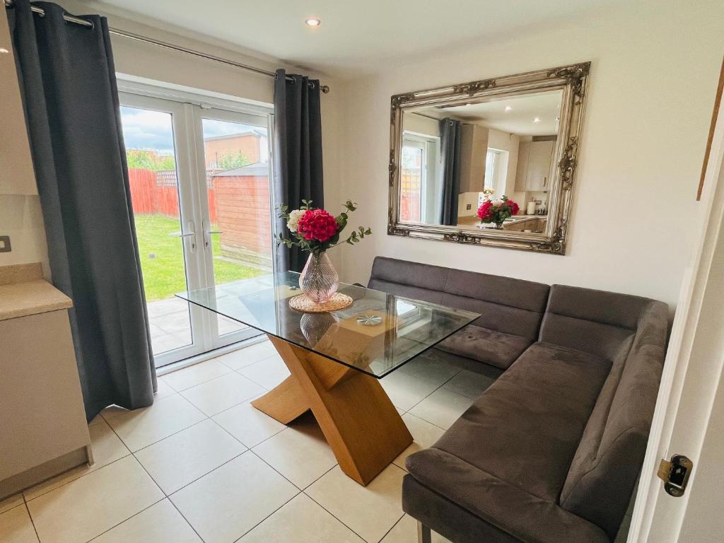 a living room with a couch and a glass table at 3BR-Sleeps 6 -Walk to Etihad & AO Arena in Manchester