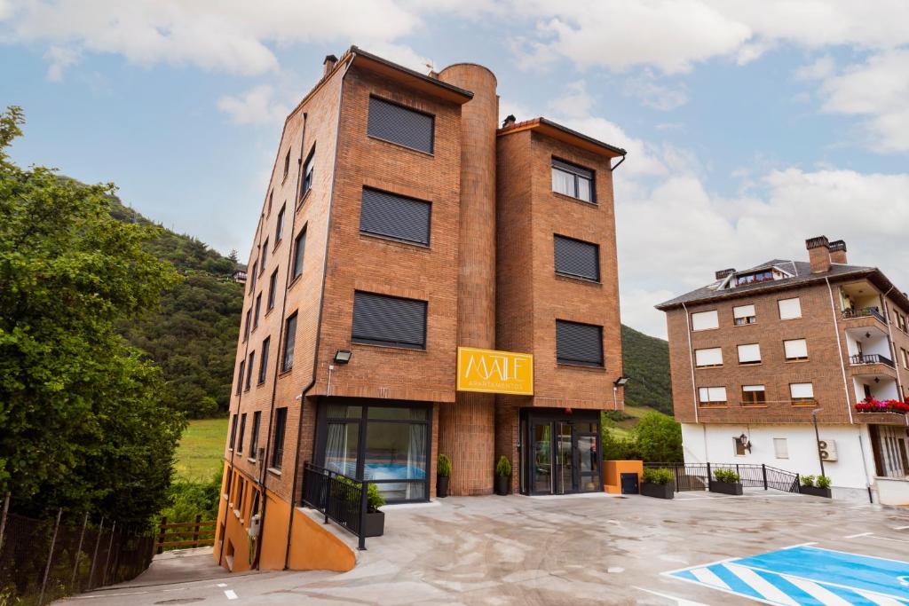 a brick building with a k rite sign on it at Maile Apartamentos in Potes