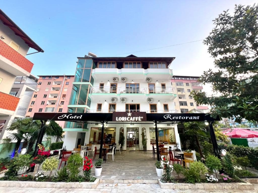 a building with a restaurant in front of it at Sangiovanni in Shëngjin