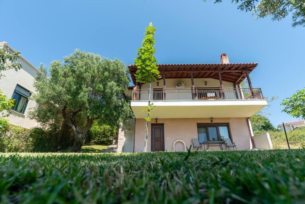 a house with a balcony on the side of it at Serenity Cove, The Fox s Lair Hospitality in Agia Paraskevi