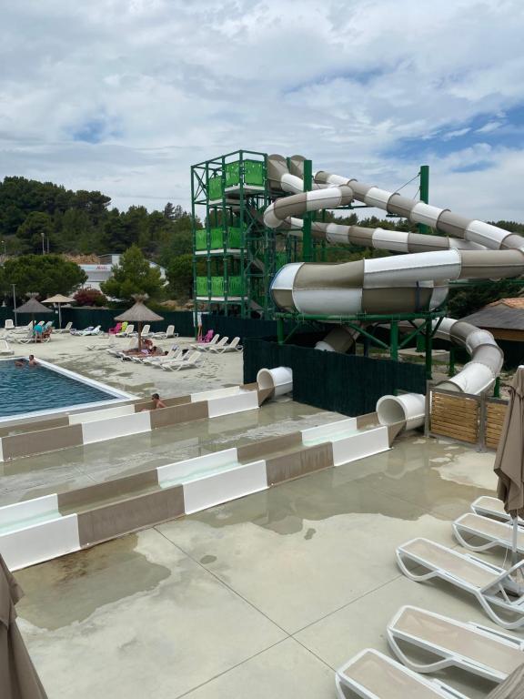 a water slide at a resort with a pool at Mobil Home 4 personnes in Narbonne-Plage