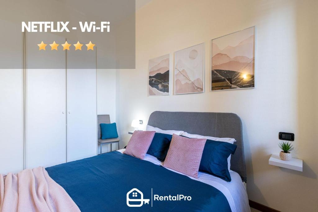 a bedroom with a bed with blue and pink pillows at [Sweet Arona] Beautiful Apartment, Netflix - Wi-Fi in Arona