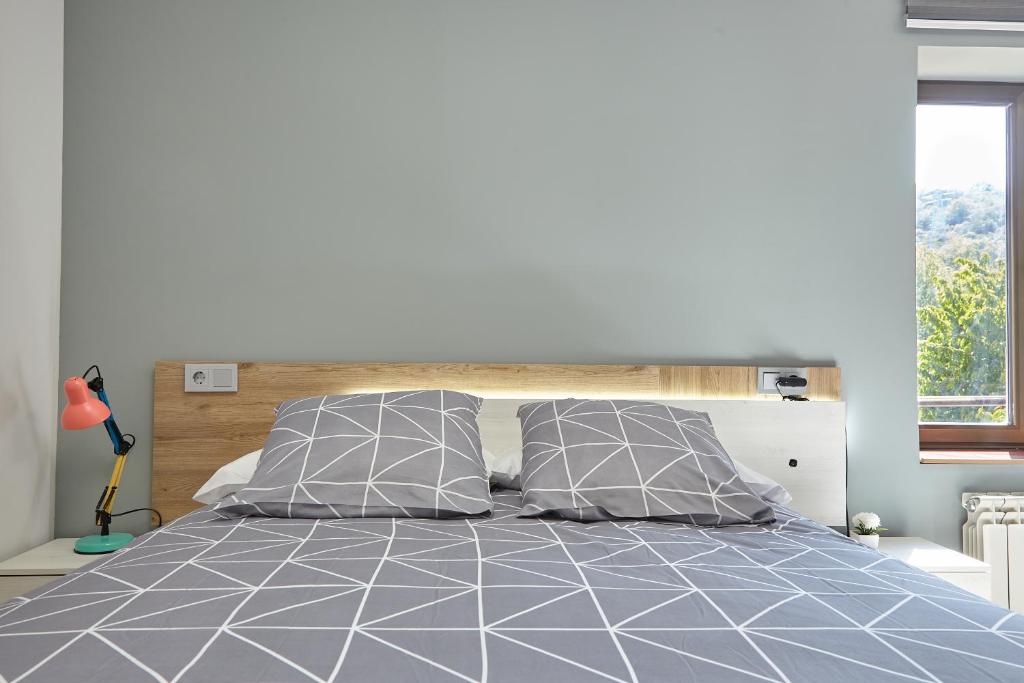 Postel nebo postele na pokoji v ubytování HOSTAL FONTAÑAN
