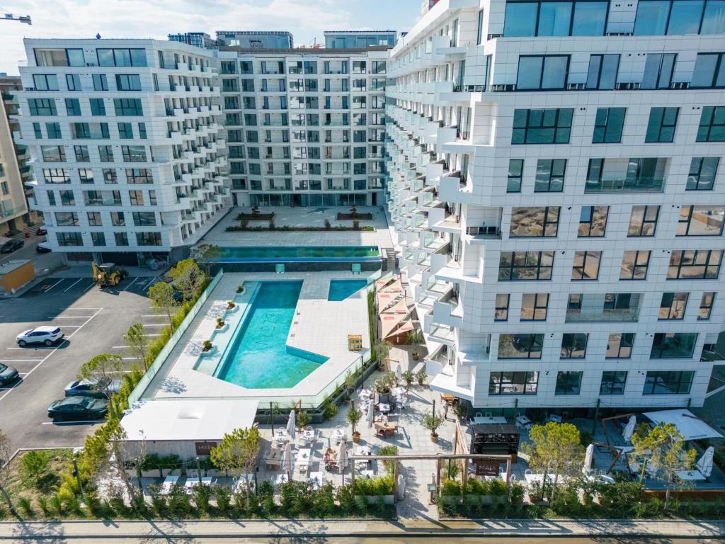 una vista aérea de una piscina frente a los edificios en David & Andrei Infinity en Mamaia Nord – Năvodari