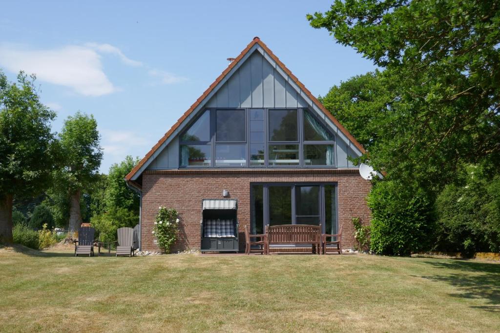 a red brick house with a large window at Ferienhaus "SonnenInsel Fehmarn" 9015 - Fehmarn in Fehmarn