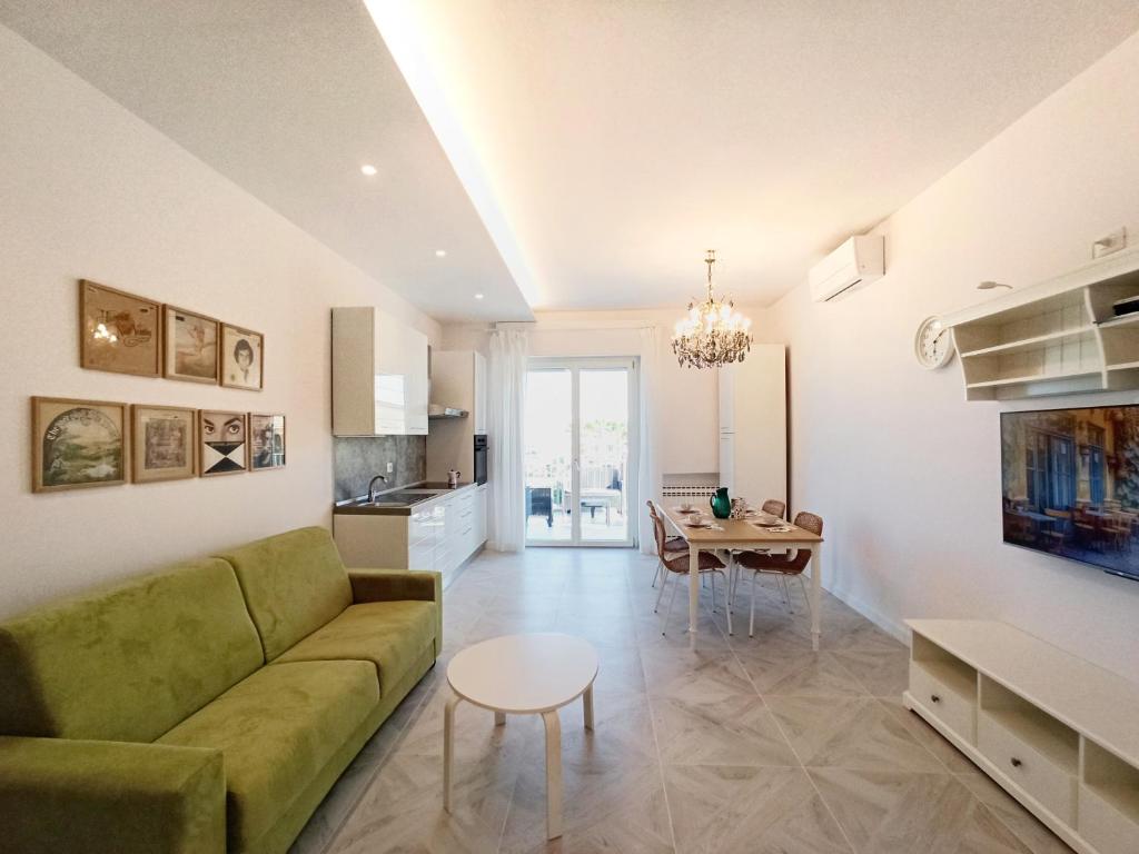 a living room with a green couch and a table at Colombo 477 Auditorium in Civitanova Marche
