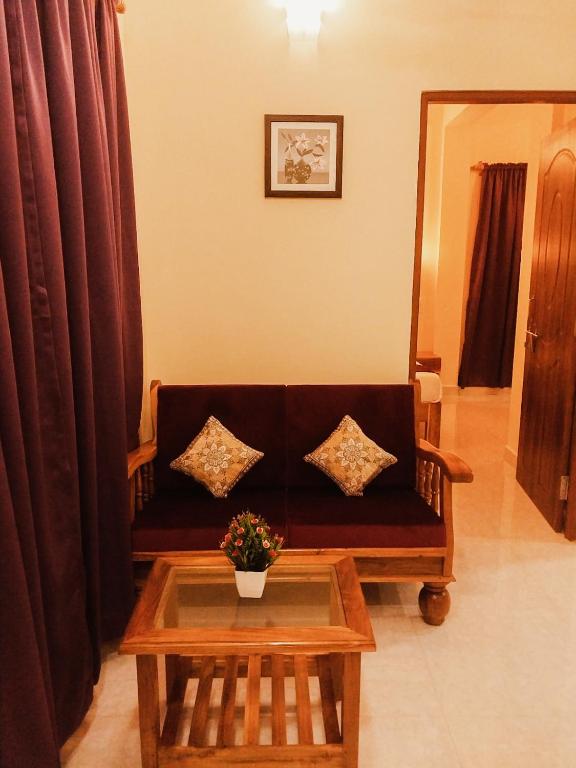 a living room with a couch and a table at Casa De Menorah in Nerul