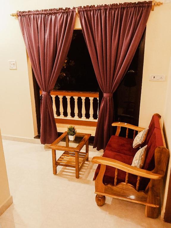 a living room with a couch and a window at Casa De Menorah in Nerul