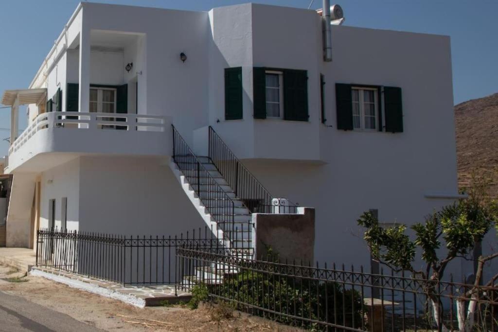 a white building with stairs in front of it at St' Amiralidika Houses in Kómi