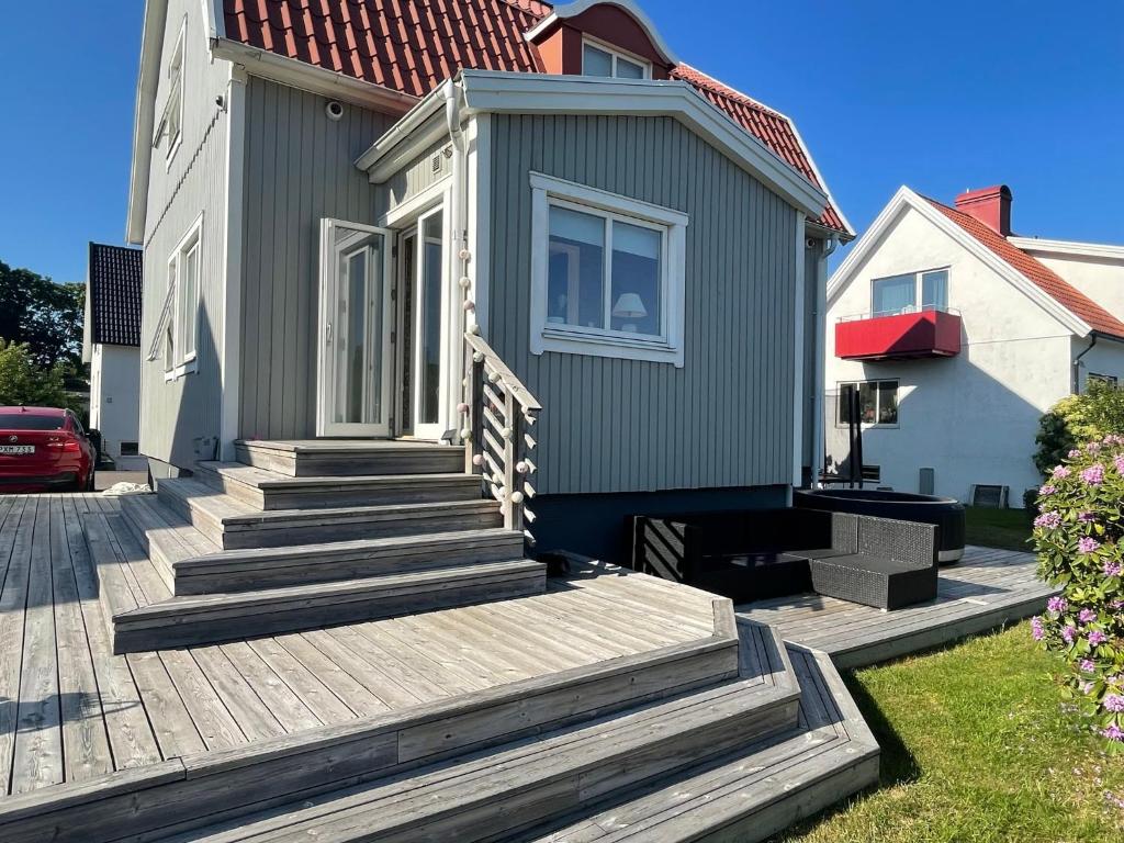 a house with a wooden staircase in front of a house at Villa Rydholm 15 minutes from Gothenburg Center in Gothenburg