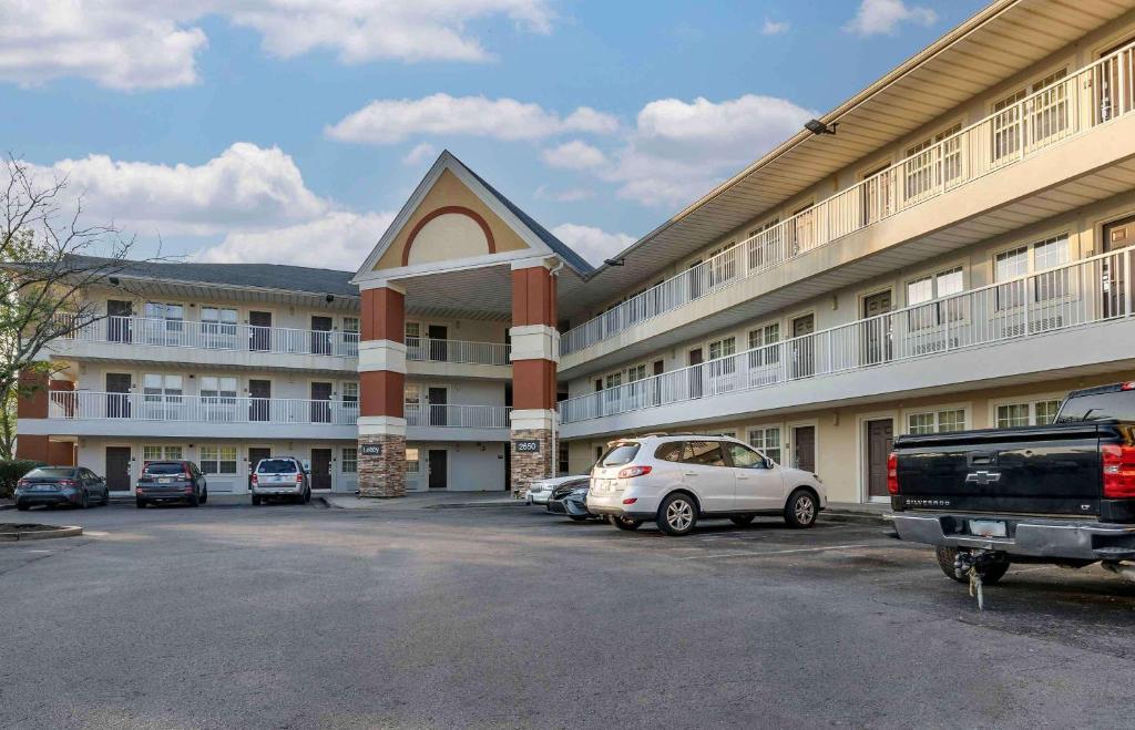 a large building with cars parked in a parking lot at Extended Stay America Suites - Lexington - Nicholasville Road in Lexington