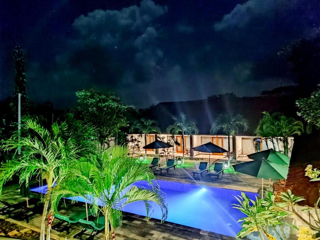 a resort with a swimming pool at night at The Bali Menjangan Boutique Villas & Dive Center in Pemuteran