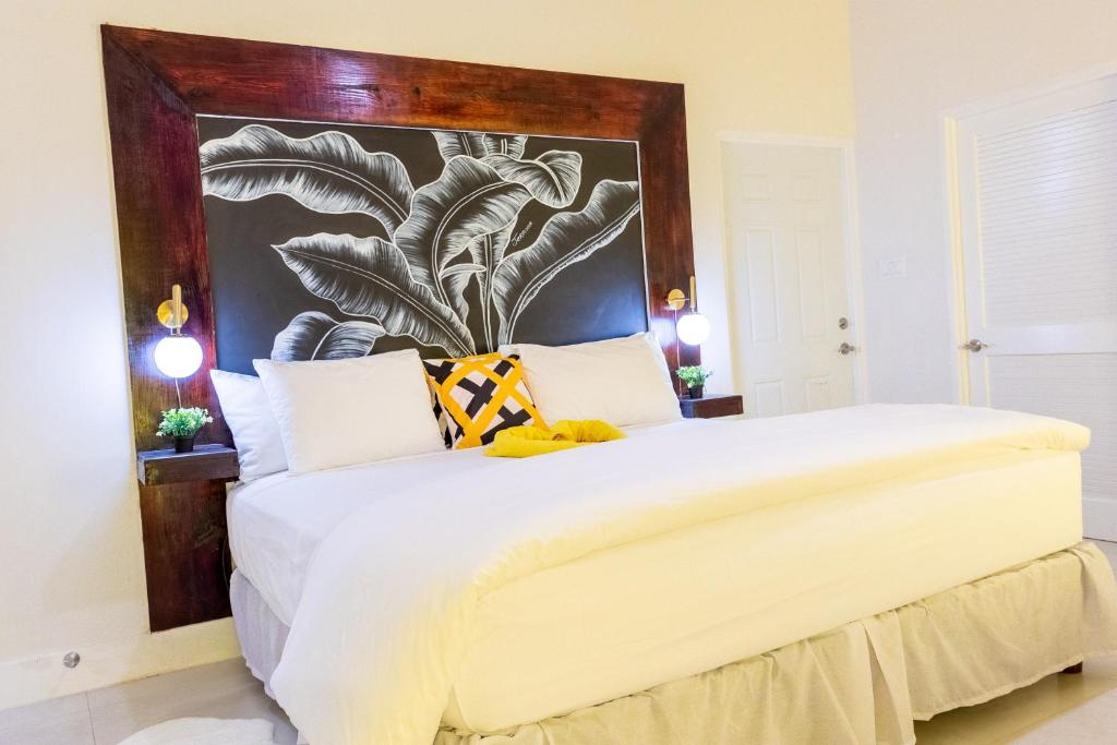 a bedroom with a large bed with a large headboard at King Bed Studio/Gated/Fast Wi-Fi/Near Ocho Rios in Boscobel