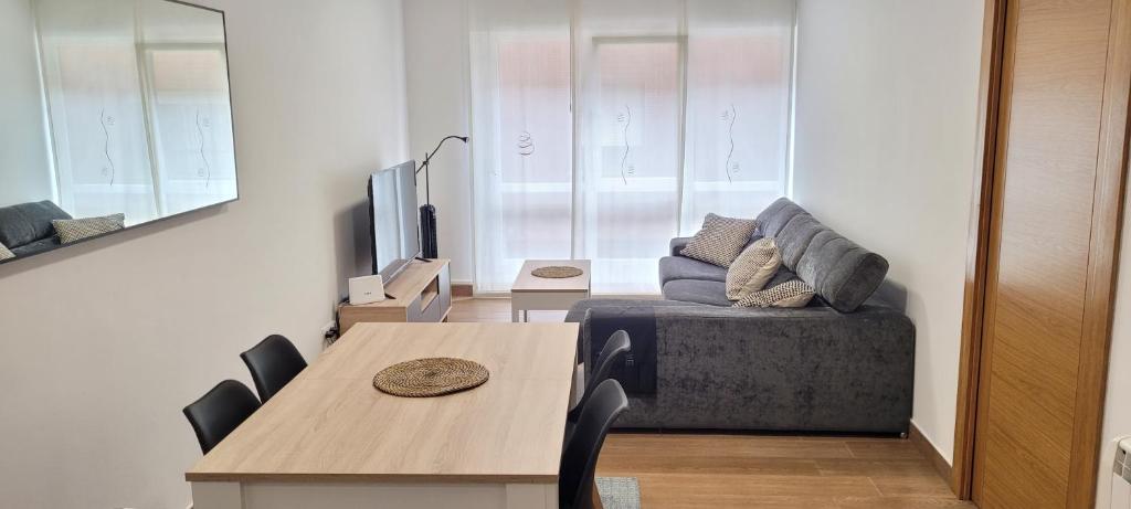 a living room with a table and a couch at STAY HOME GETXO Metro and Beach in Getxo