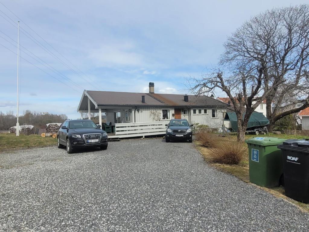 a house with two cars parked in the driveway at Hus ved Lillestrøm by in Lillestrøm