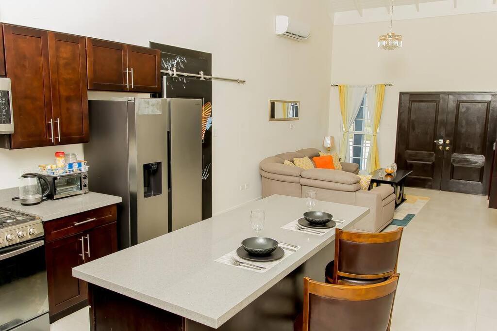 a kitchen with a white counter top and a refrigerator at Modern & Spacious 2-BDRM/ Gated/Near Ocho Rios in Boscobel