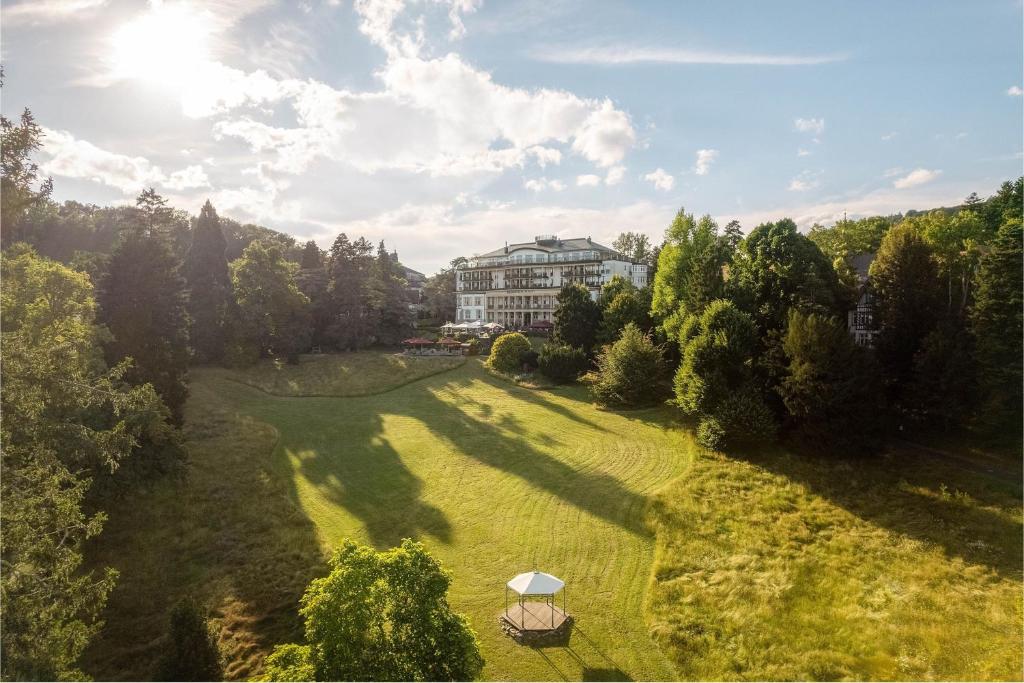an overhead view of a large green field with a building at Falkenstein Grand, Autograph Collection in Königstein im Taunus